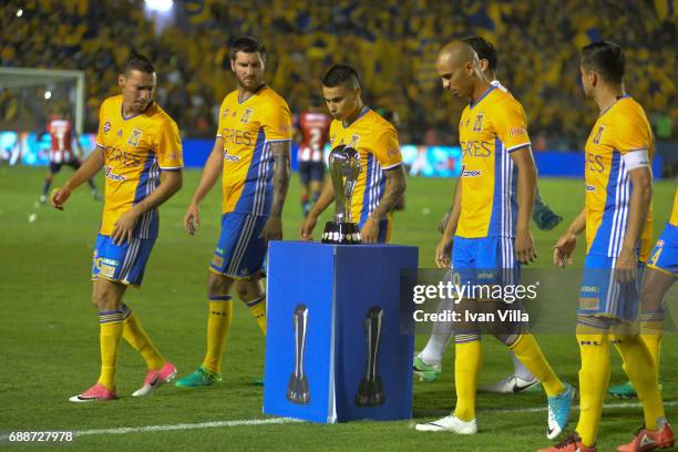 Andre Gignac, Lucas Zelarayan, Luis Rodriguez and Jesus Dueñas of Tigres look at the Trophy during the Final first leg match between Tigres UANL and...