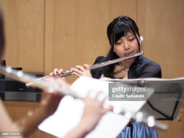 woman playing a flute - soundproof room stock pictures, royalty-free photos & images