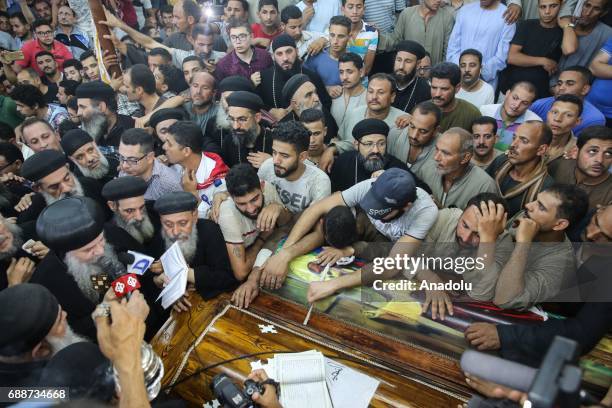 Relatives of Saint Samuel's Monastery attack victims Cercis Mahrous and Beshavi Ibrahim mourn during a funeral ceremony at Maghagha Church in Cairo,...