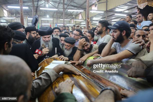 Relatives of Saint Samuel's Monastery attack victims Cercis Mahrous and Beshavi Ibrahim mourn during a funeral ceremony at Maghagha Church in Cairo,...