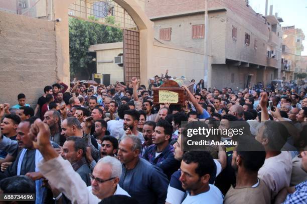 People carry the coffins of Saint Samuel's Monastery attack victims Cercis Mahrous and Beshavi Ibrahim during a funeral ceremony, at Maghagha Church...