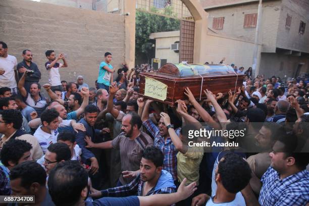 People carry the coffins of Saint Samuel's Monastery attack victims Cercis Mahrous and Beshavi Ibrahim during a funeral ceremony, at Maghagha Church...