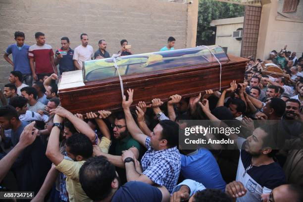 People carry the coffins of Saint Samuel's Monastery attack victims Cercis Mahrous and Beshavi Ibrahim during a funeral ceremony, at Maghagha Church...