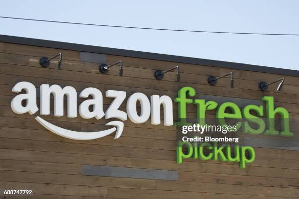 Signage is displayed at an AmazonFresh Pickup location in Seattle, Washington, U.S., on Friday, May 26, 2017. Amazon.com Inc. Opened two grocery...