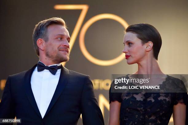 Belgian actor Jeremie Renier and French actress Marine Vacth pose as they leave the Festival Palace on May 26, 2017 following the screening of the...