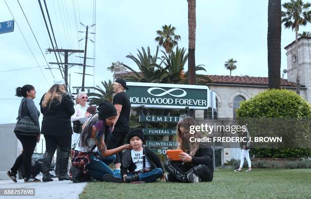 Soundgarden fans, including Melody Andrade,is seen with her son Jude both wearing a "Say hello 2 Heave" t-shirt, joining others waiting outside the...