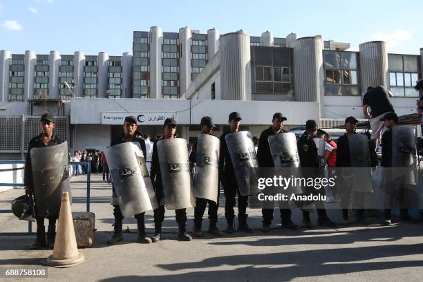 Egyptian security forces take security measures in front of the Nasser Institute For Research and Treatment, as wounded people of St. Samuels...