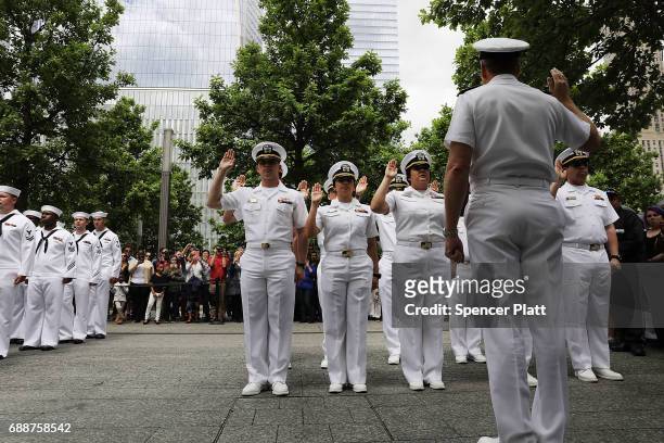 Members of the U.S. Navy and Coast Guard participate in a military re-enlistment and promotion ceremony outside of the 9-11 Memorial on May 26, 2017...