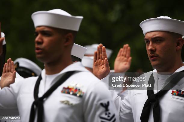 Members of the U.S. Navy and Coast Guard participate in a military re-enlistment and promotion ceremony outside of the 9-11 Memorial on May 26, 2017...