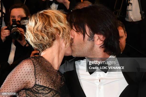 German director Fatih Akin kisses German actress Diane Kruger as they arrive on May 26, 2017 for the screening of the film 'In the Fade' at the 70th...