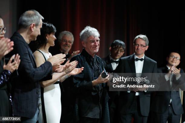 Actress Juliette Binoche is seen on stage as director Christopher Doyle accepts the "Pierre Angenieux ExcelLens in Cinematography" award onstage at...