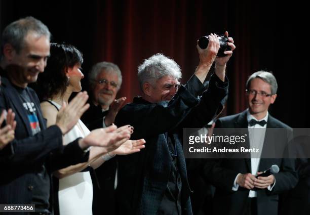 Actress Juliette Binoche is seen on stage as director Christopher Doyle accepts the "Pierre Angenieux ExcelLens in Cinematography" award onstage at...