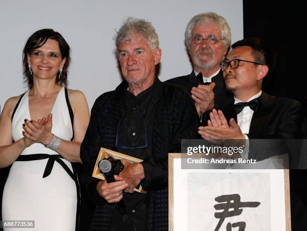 Actress Juliette Binoche is seen on stage as director Christopher Doyle accepts the "Pierre Angenieux ExcelLens in Cinematography" award onstage at...