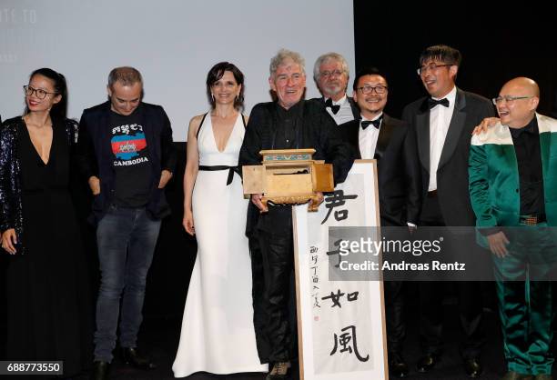 Rain Li , Juliette Binoche are seen on stage while Director Christopher Doyle accepts the "Pierre Angenieux ExcelLens in Cinematography" award...