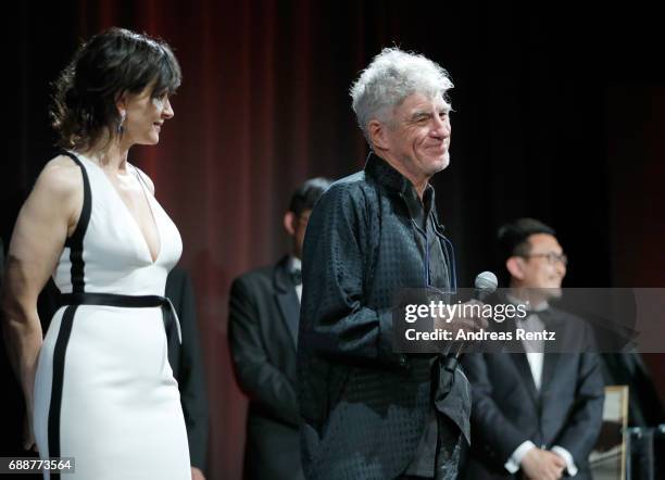 Juliette Binoche is seen on stage while Director Christopher Doyle accepts the "Pierre Angenieux ExcelLens in Cinematography" award onstage at the...