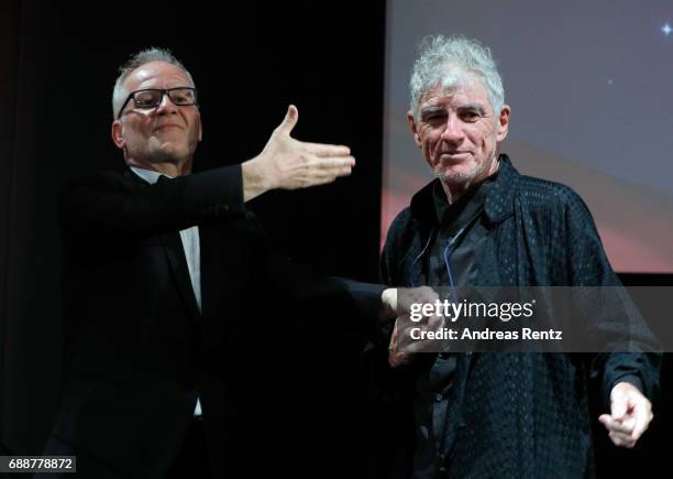 Thierry Fremaux and Christopher Doyle greet each other on stage during the Tribute to Christopher Doyle during the 70th annual Cannes Film Festival...