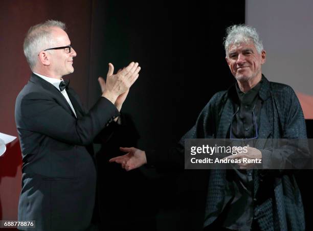 Thierry Fremaux and Christopher Doyle greet each other on stage during the Tribute to Christopher Doyle during the 70th annual Cannes Film Festival...