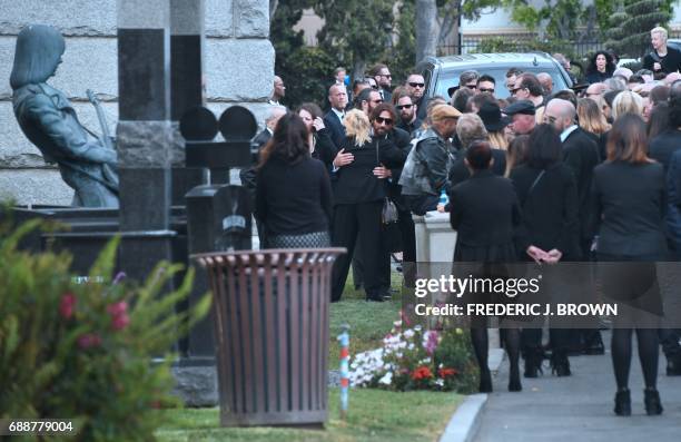 Condolences and hugs are offered and exchanged following a service at the funeral for Soundgarden frontman Chris Cornell on May 26, 2017 at the...