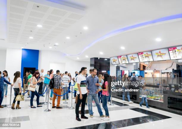 people buying food at the cinema before watching a movie - cinema interior stock pictures, royalty-free photos & images