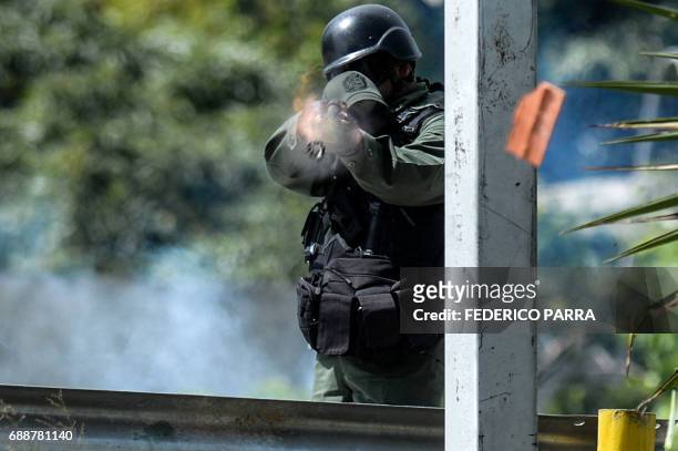 Riot policeman confronts opposition activists during a demostration against Venezuelan President Nicolas Maduro in Caracas, on May 26, 2017. Both the...