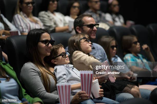 happy family watching a movie at the cinemas with 3d glasses - family portrait 3d stock pictures, royalty-free photos & images