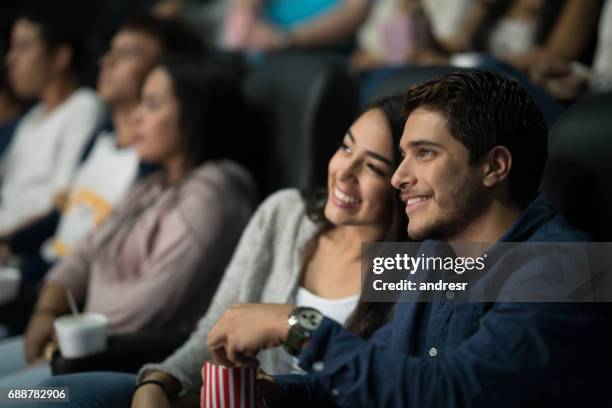 couple watching a movie at the cinema - get out film 2017 stock pictures, royalty-free photos & images