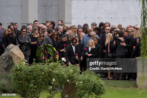 Family members lay flowers graveside at funeral services for Soundgarden frontman Chris Cornell at Hollywood Forever Cemetery on May 26, 2017 in...