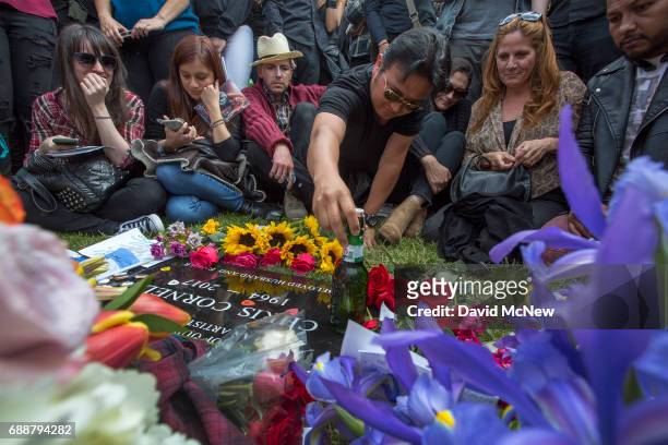Fan leaves a graveside offering of beer after funeral services for Soundgarden frontman Chris Cornell at Hollywood Forever Cemetery on May 26, 2017...