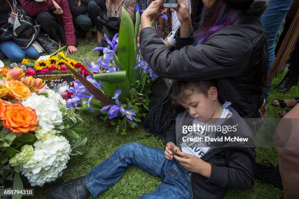 Boy wears a shirt referencing the song, Say Hello to Heaven, as fans mourn graveside after funeral services for Soundgarden frontman Chris Cornell at...