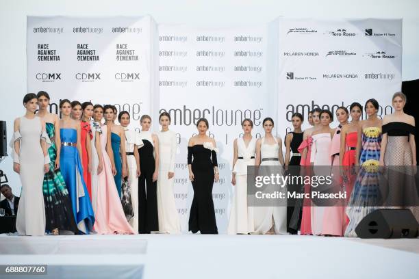 SAFiYAA designer Daniela Karnuts poses with models on the runway during the Amber Lounge 2017 on May 26, 2017 in Monaco, Monaco.