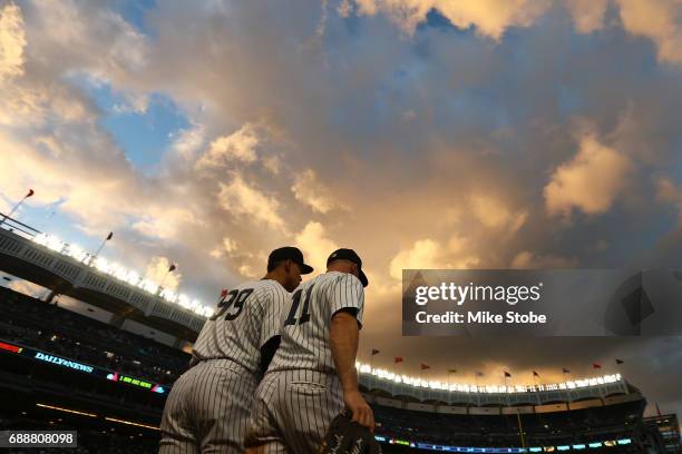 Aaron Judge and Brett Gardner of the New York Yankees take the field in the third inning against the Oakland Athletics at Yankee Stadium on May 26,...