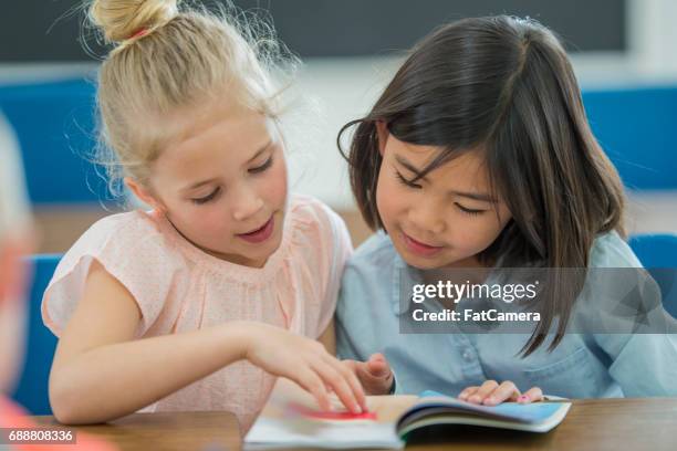 reading together - elementary student classroom stock pictures, royalty-free photos & images