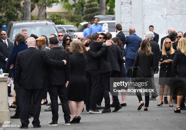 People hug at the funeral and memorial service for Soundgarden frontman Chris Cornell, May 26, 2017 at Hollywood Forever Cemetery in Los Angeles,...