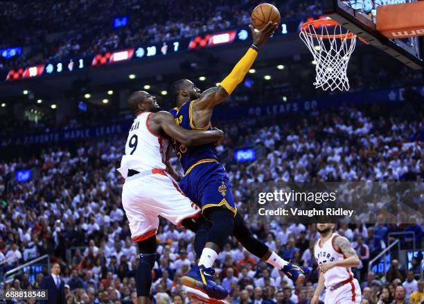 Lebron James of the Cleveland Cavaliers drives to the basket as Serge Ibaka of the Toronto Raptors defends in the first half of Game Four of the...