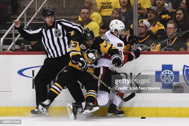 Pittsburgh Penguins center Scott Wilson checks Ottawa Senators center Derick Brassard into the boards during the third period. The Pittsburgh...