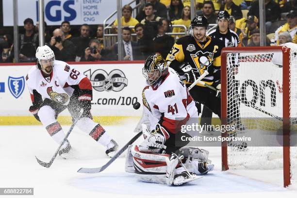 Ottawa Senators goalie Craig Anderson makes a save as Pittsburgh Penguins Center Sidney Crosby and Ottawa Senators defenseman Erik Karlsson react...