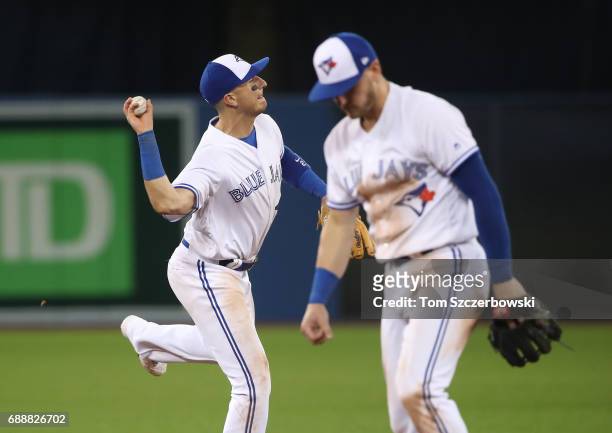 Troy Tulowitzki of the Toronto Blue Jays makes the play and throws out the baserunner as Josh Donaldson turns away in the ninth inning during MLB...
