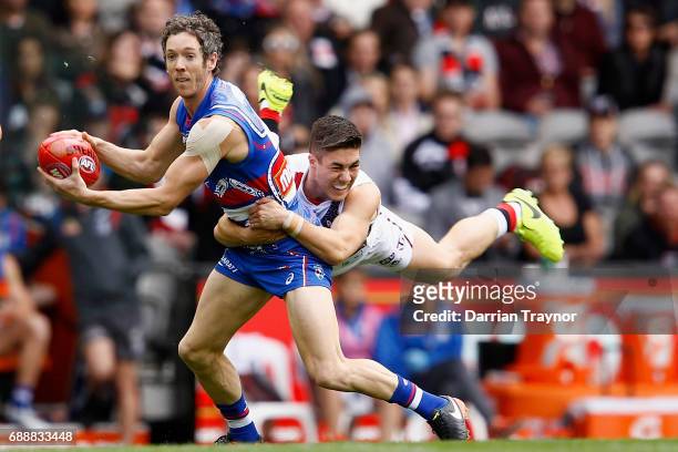 Jade Gresham of the Saints tackles Robert Murphy of the Bulldogs during the round 10 AFL match between the Western Bulldogs and the St Kilda Saints...