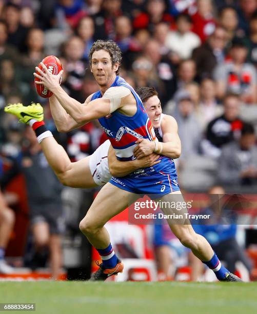 Jade Gresham of the Saints tackles Robert Murphy of the Bulldogs during the round 10 AFL match between the Western Bulldogs and the St Kilda Saints...