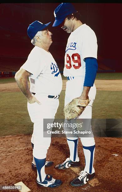 Los Angeles baseball manager Tommy Lasorda, left, speaks with actor Chevy Chase wearing Los Angeles Dodgers uniforms on the set of the movie...