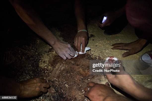 Relatives of the victims of the bus attack taking some sand tgat mixed with blood during the way back from the funeral service, at Ava Samuel desert...