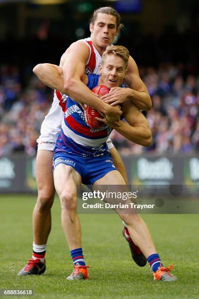 Jack Steele of the Saints tackles Lachie Hunter of the Bulldogs during the round 10 AFL match between the Western Bulldogs and the St Kilda Saints at...