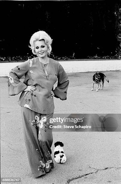 Actress Zsa Zsa Gabor with her pet dogs at home in Bel Air in Los Angeles, California, 1975.