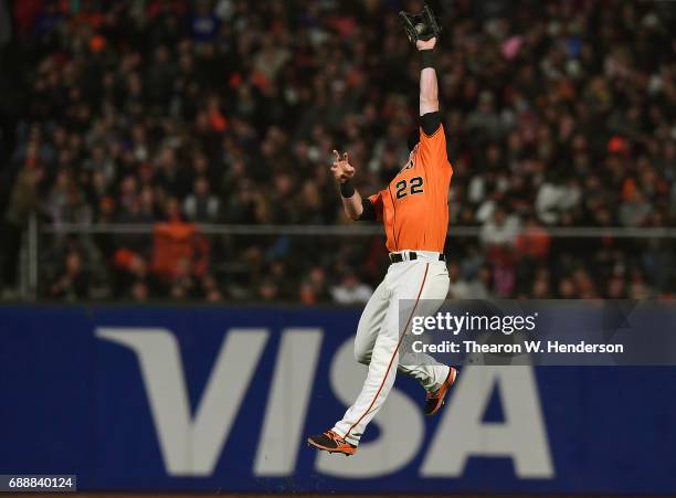 Christian Arroyo of the San Francisco Giants leaps to rob a hit from Ender Inciarte of the Atlanta Braves in the top of the seventh inning at AT&T...