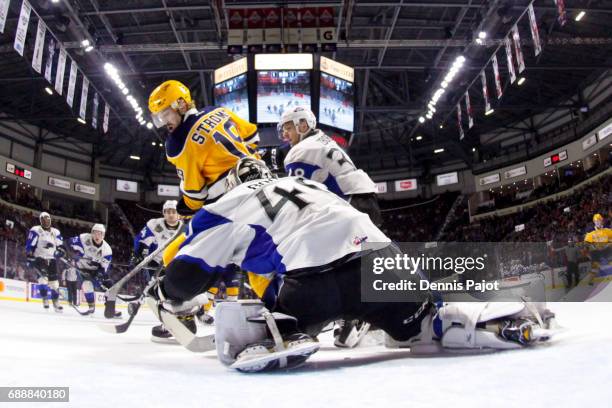 Forward Dylan Strome of the Erie Otters moves the puck against goaltender Callum Booth of the Saint John Sea Dogs on May 26, 2017 during the...