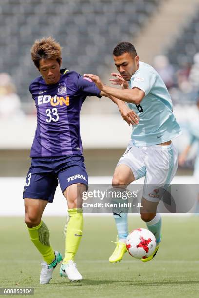 Tsukasa Shiotani of Sanfrecce Hiroshima and Fozil Musaev of Jubilo Iwata compete for the ball during the J.League J1 match between Sanfrecce...