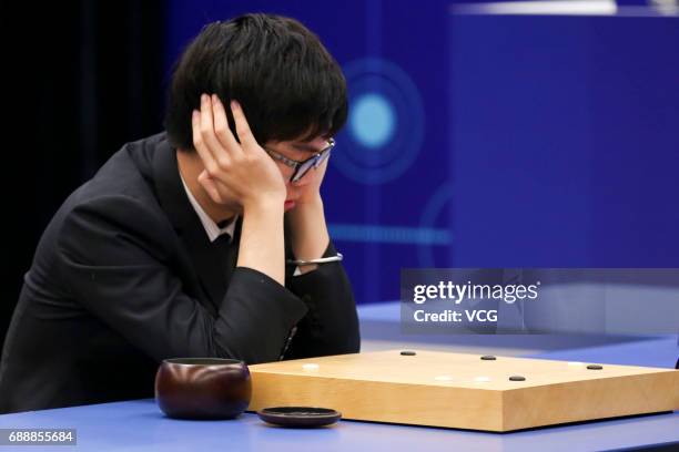 Chinese Go player Ke Jie competes against Google's artificial intelligence program AlphaGo at his third round game during the Future of Go Summit at...