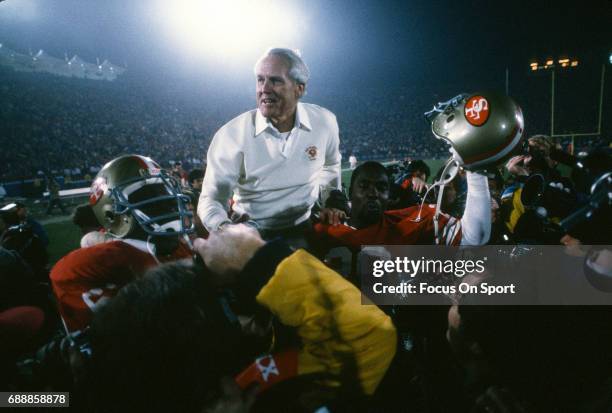 Head Coach Bill Walsh of the San Francisco 49ers is carried off the field on the shoulders of two of his players after the 49ers defeated the Miami...