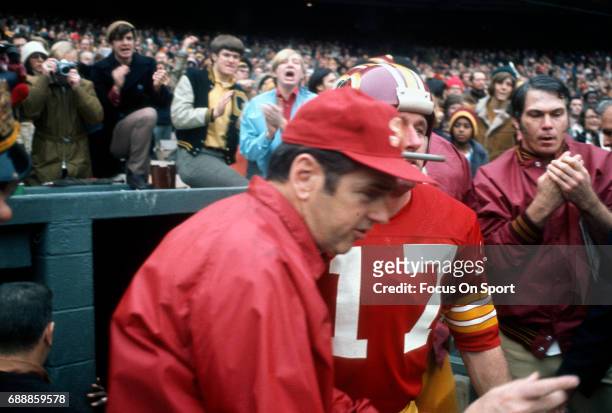 Head coach George Allen of the Washington Redskins runs onto the field with Billy Kilmer prior to the start of an NFL football game circa 1972 at RFK...