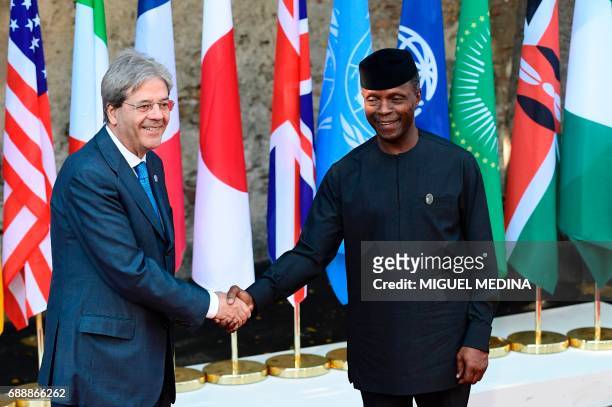 Italian Prime Minister Paolo Gentiloni welcomes Vice President of Nigeria Yemi Osinbajo as he arrives at the Hotel San Domenico on the second day of...